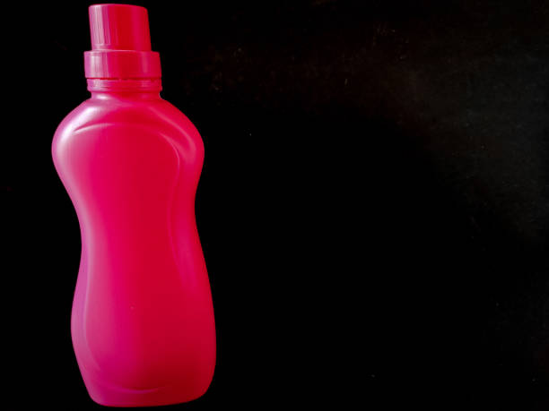 istock Product display. Pink color detergent bottle isolated on black background. 1279347406