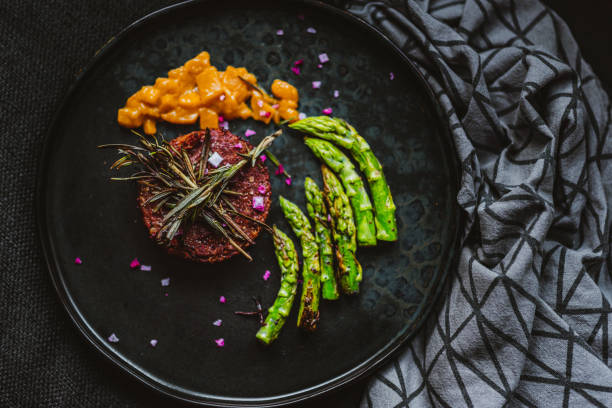 Gourmet Vegan Burger Served with Grilled Asparagus and Mango Chutney Gourmet Vegan Burger Served with Grilled Asparagus and Mango Chutney Topped with Pink Himalaya Salt low carb diet photos stock pictures, royalty-free photos & images