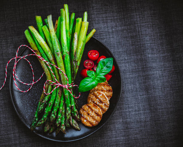 istock Grilled Asparagus Served with Cocktail Tomatoes and 1279348267