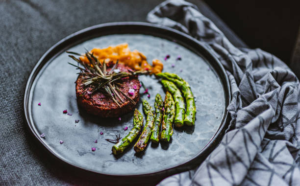 istock Gourmet Vegan Burger Served with Grilled Asparagus and Mango Chutney 1279351156