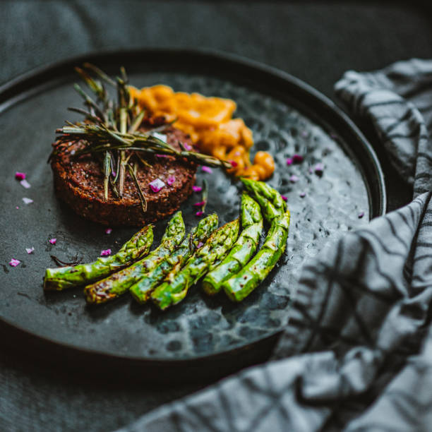 istock Gourmet Vegan Burger Served with Grilled Asparagus and Mango Chutney 1279351292