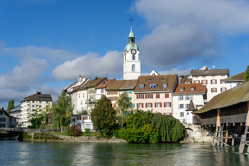 Olten, SO / Switzerland - 8 October 2020: view of the Aare river and the historic old town of Olten and wooden bridge