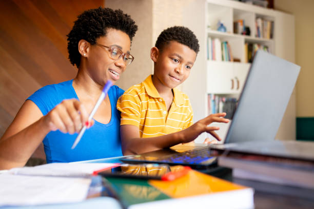 istock Mother helping son in his online studies at home 1279354115