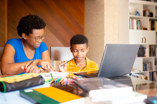 istock Mother helping son in his online studies at home 1279354129
