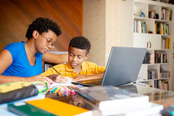 istock Mother helping son in his online studies at home 1279354316