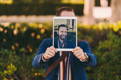 Man showing self portrait on tablet