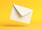 Envelope falling on the ground on a yellow backgorund