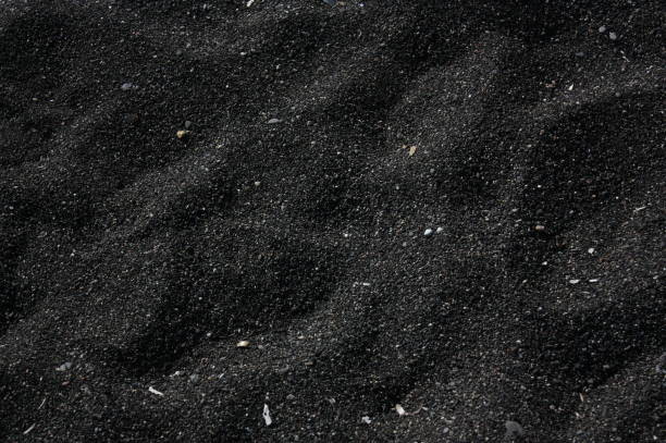 black and white sand texture on a beach stock photo