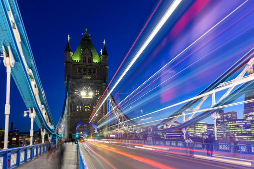 Long exposure shot taken at the Tower Bridge, London, United Kingdom. The light trails in this photo was captured in the blue hour, when the iconic red bus of London was passing by.