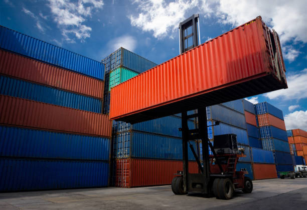 istock Forklift truck handling container box in shipping industry 1279362359