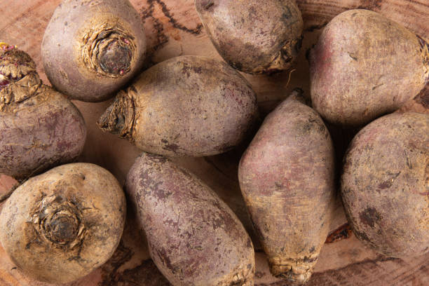 istock Pile of beets on wooden board and rustic background. Top view. 1279364225