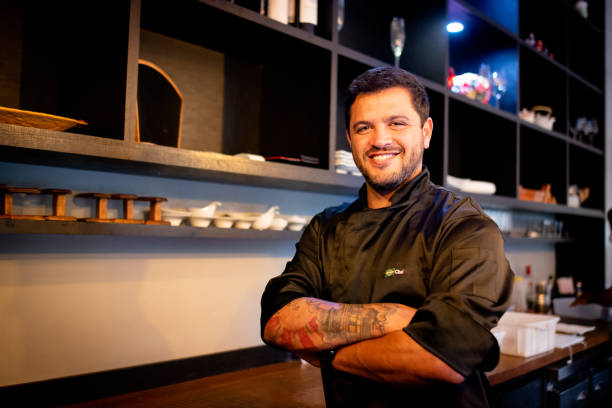 istock Waiter in a restaurant smiling and looking at camera 1279365213