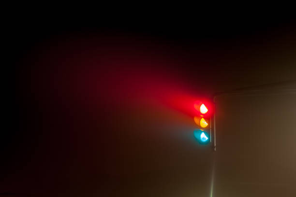 Early in the morning on the road you have these traffic lights in the thick fog