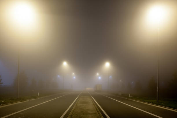 istock Road with lights in the fog 1279365257