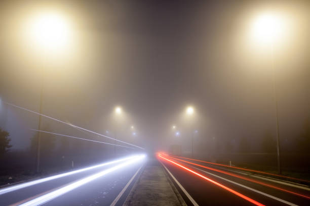istock Road with lights in the fog 1279365260