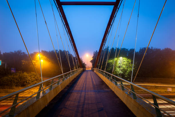 istock Bridge over freeway in the early morning with fog 1279365270