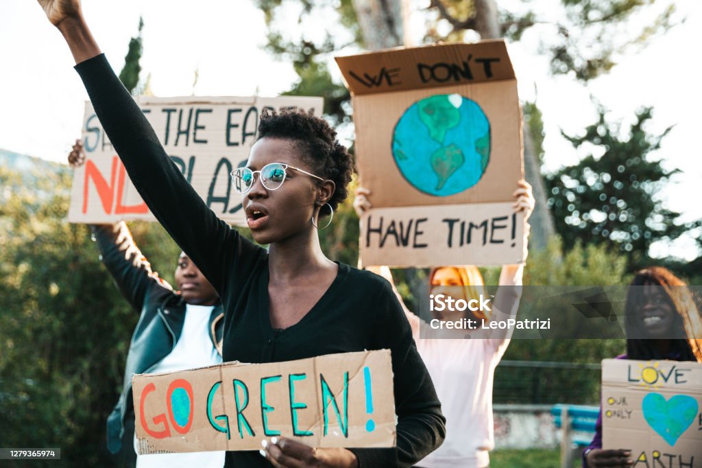 Activists demonstrating against global warming Young group of teenagers activists demonstrating against global warming. Protest Stock Photo