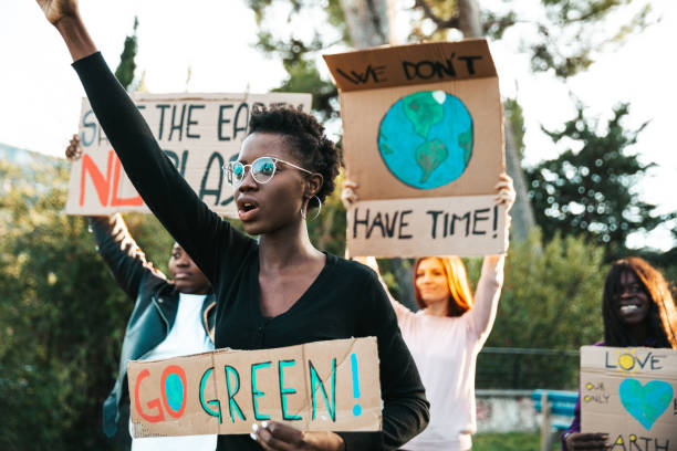 activists demonstrating against global warming - protest imagens e fotografias de stock