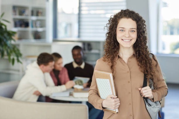 istock Smiling Young Woman in Library 1279365987