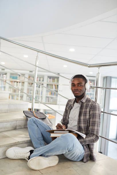 istock African-American Man Sitting on Stairs in School 1279366029