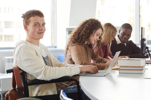istock Wheelchair User in College 1279366078