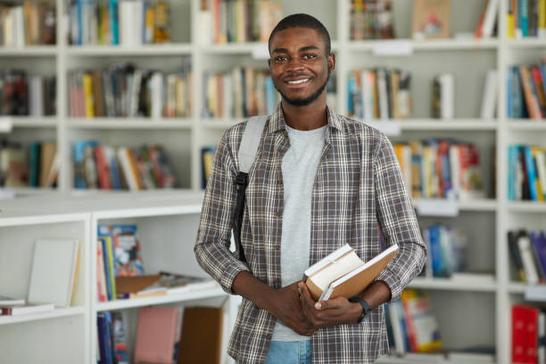 istock Smiling African-American Man in College Library 1279366129