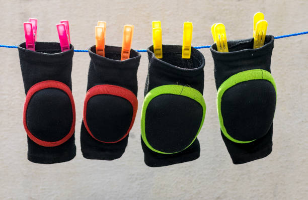 Colorful soaked knee pads attached on nylon wire for drying after wash. Colorful soaked knee pads attached on nylon wire for drying after wash. kneepad stock pictures, royalty-free photos & images