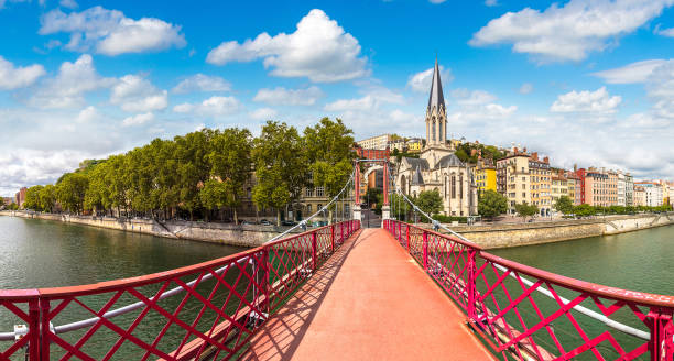 Footbridge in Lyon, France Pedestrian Saint Georges footbridge and the Saint Georges church in Lyon, France in a beautiful summer day lyon photos stock pictures, royalty-free photos & images