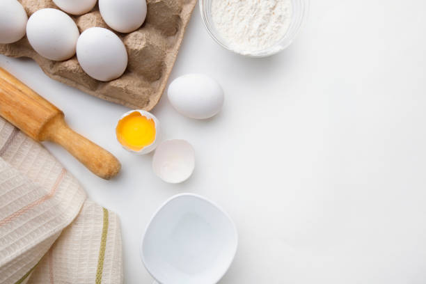 istock Baking cooking ingredients flour eggs rolling pin and kitchen textiles on a white background. Cookie pie or cake recipe mockup 1279368515