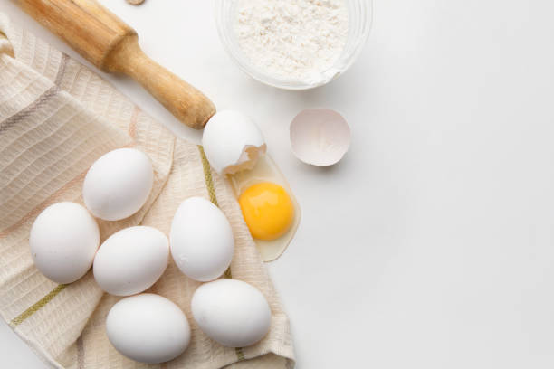 istock Baking cooking ingredients flour eggs rolling pin and kitchen textiles on a white background. Cookie pie or cake recipe mockup 1279368520
