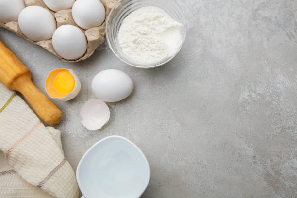 istock Baking cooking ingredients flour eggs rolling pin and kitchen textiles on gray concrete background. Cookie pie or cake recipe mockup 1279368600