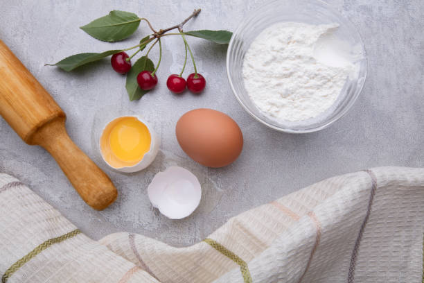 istock Ingredients baking flour eggs rolling pin berries kitchen textiles on gray background. Cookie pie or cake recipe mockup. Background preparation for culinary baking. 1279368617