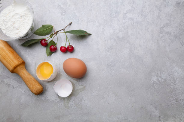 istock Ingredients for baking eggs rolling pin berries on a gray background. Cookie pie or cake recipe mockup. Preparing for culinary baking. 1279368630