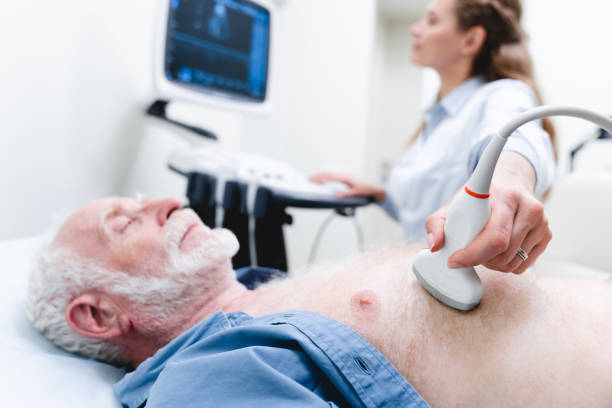 Cropped photo of a senior male patient heart examination with ultrasound by woman doctor Cropped photo of a senior male patient heart examination with ultrasound by woman doctor ultrasound photos stock pictures, royalty-free photos & images