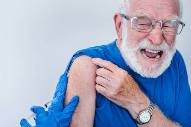 istock Crying old man in glasses is afraid of being vaccinated isolated over white background 1279370402