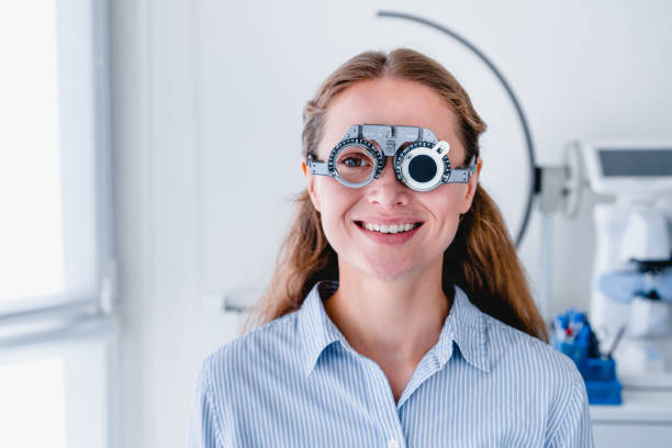 istock Smiling young female patient checking up sight using ophthalmic glasses 1279370445