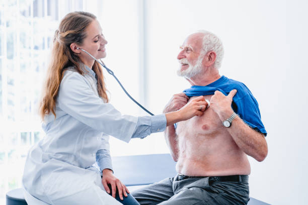 istock Smiling woman doctor is using stethoscope to diagnose elderly patient 1279370988