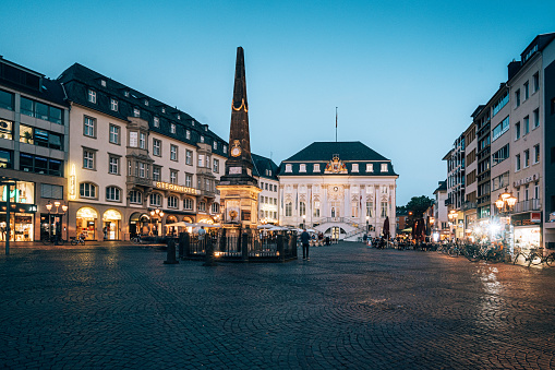 market square in Bonn / Germany with the old town hall in background. Many restaurants are located around this place. Some tourist walking around.