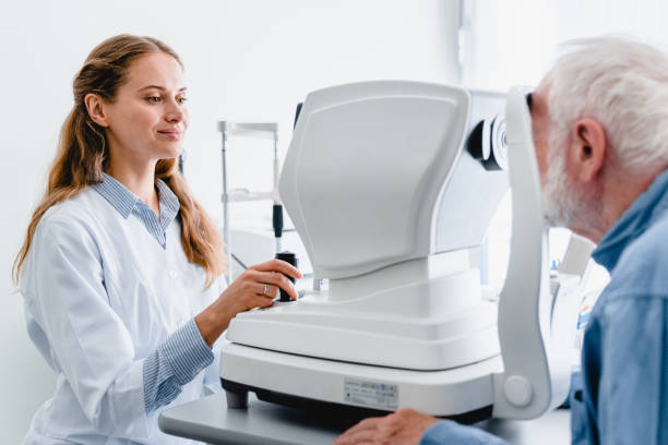 istock Young female oculist checking senior male patient`s vision using special equipment 1279371065
