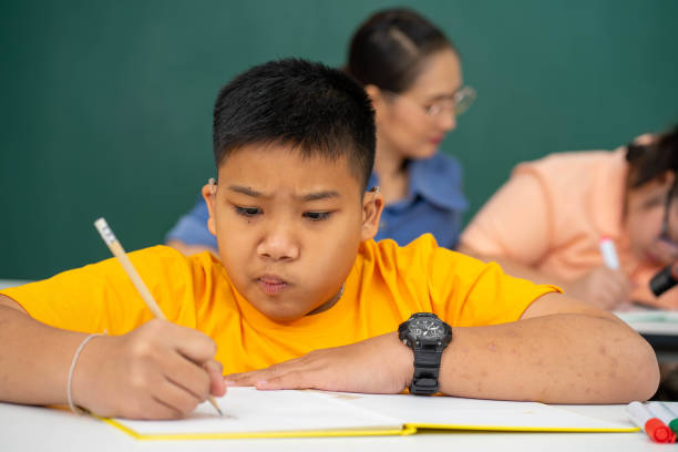 istock disability kid with autism boy in special classroom studying with Asian teacher 1279372580