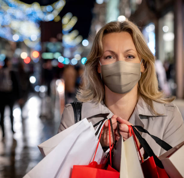 istock Woman wearing a facemask while doing her Christmas shopping 1279375785