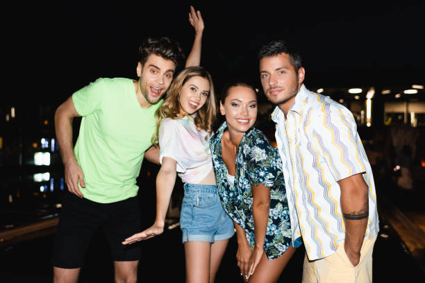 istock Young friends looking at camera outdoors at night 1279378281