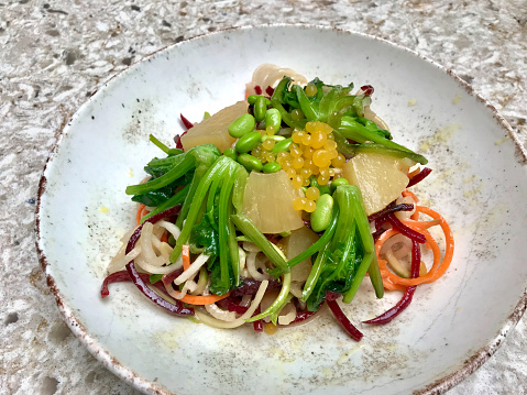 Salad with Pineapple, Spinach Roots, Edamame Beans, Vegetables and Orange Globule Bubbles.