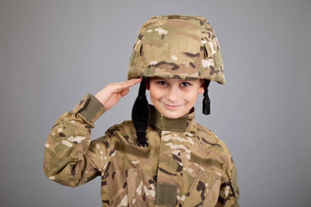 istock Saluting soldier. Young boy dressed like a soldier 1279381305