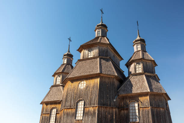 Wooden vintage church, Zaporozhian Sich village Wooden vintage church in Zaporozhian Sich medieval village, state of Cossacks on Khortytsia island, Ukraine. Sunny blue bright clear day cossack stock pictures, royalty-free photos & images