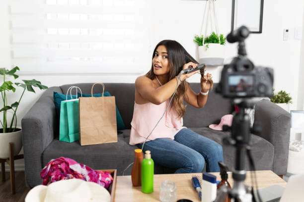 istock Influencer woman doing her hair on video 1279384249