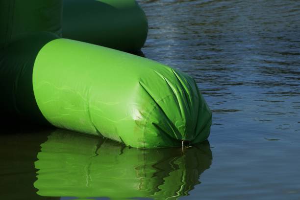 istock one green large plastic bag lies on the water 1279387480