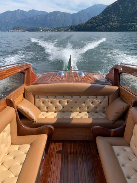Ellegant wooden boat Wooden classic boat on the Lake Como in Italy lake como photos stock pictures, royalty-free photos & images