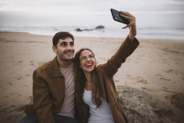 istock Young couple taking a selfie at a beach 1279390605