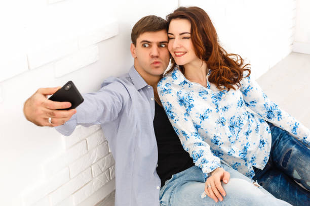 istock Beautiful loving couple making selfie on smartphone. Sel isolation and covid19 quarantine 1279390685